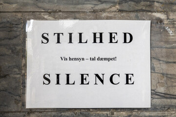Copenhagen, Denmark A sign in a church entrance says in Danish to be quiet. "Silence, Show respect, Speak softly."
