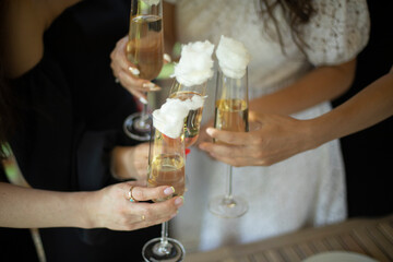 Girls hold glasses of wine. Party details. Wedding celebration.