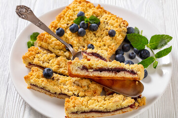 sliced blueberry crumble pie on plate, top view