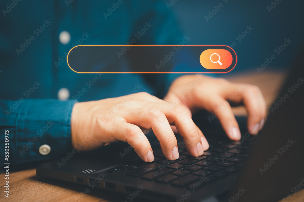 Poster Freelance's hand working with computer laptop on desk in home. Searching Browsing Internet Data Information with blank search bar. Search Engine Optimization SEO Networking Concept.