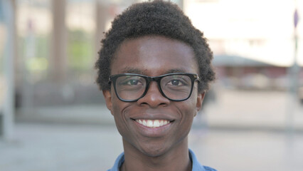 Close Up of Young African Man Smiling at Camera Outdoor
