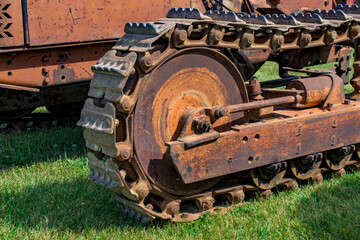 Fototapeta na wymiar Equipment on display at the NY Steam Engine Association Pageant of Steam in Canandaigua in Upstate NY. Tracks of an old tractor.