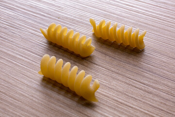 small group of durum wheat pasta on wooden background