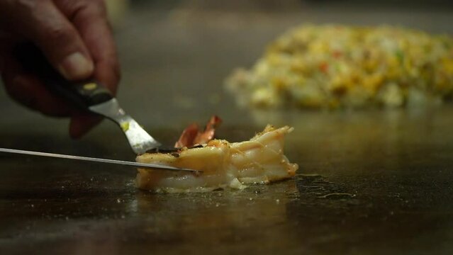 Teppanyaki Restaurants chef fry two prawns in Japanese style