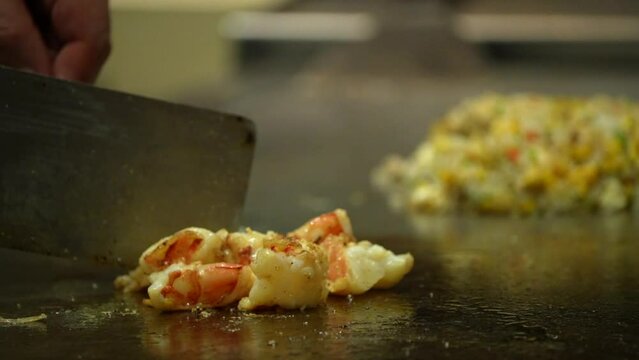 Teppanyaki Restaurants prowns  shrimps frying in butter smoke on pan