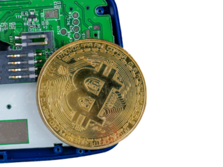 gold crypto curency coin on a circuit board 