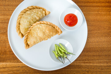 Kue Pastel or fried patties or empanadas, a popular snack in Indonesia with the skin filled with various fillings such as vermicelli, vegetables, chicken. With a wavy edge of dough on the side