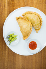 Kue Pastel or fried patties or empanadas, a popular snack in Indonesia with the skin filled with various fillings such as vermicelli, vegetables, chicken. With a wavy edge of dough on the side