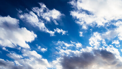 Dramatic blue sky with white clouds.