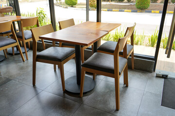 Clean, neat, comfortable, minimalist and elegant table and chair arrangement in a starbucks...
