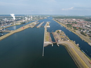 The IJmuiden locks form the connection between the North Sea Canal and the North Sea at IJmuiden . Zeesluis Ijmuiden sea lock infrastructure connecting the river with the sea.