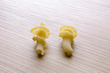 small compositions of durum wheat pasta on wooden background