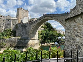 Mostar Old Bridge on the river Neretva in Bosnia and Herzegovina with greenery around at daylight
