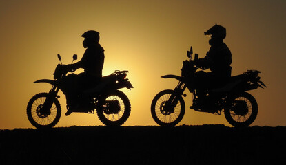 Fototapeta na wymiar two motorcycle friends at sunrise