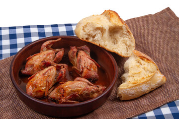 Four roasted quails and two chunk of white bread with white copy space background on top