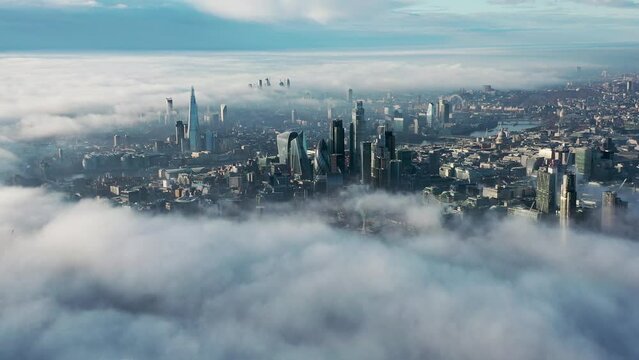 Establishment Aerial view of London clouds and fog with Tower Bridge, sky garden, The Shard, Thames River, London Eye, The Gherkin, Cityscape and Iconic commercial Skyscrapers. United Kingdom