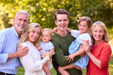 Portrait Of Multi-Generation Family Enjoying Walk In Countryside Together