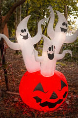 ghosts and pumpkin decor outside for Halloween