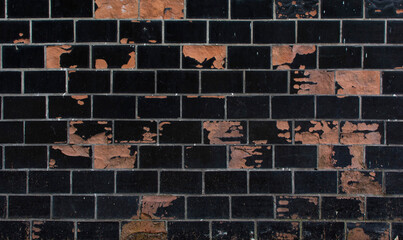 The texture of the wall with facing black bricks