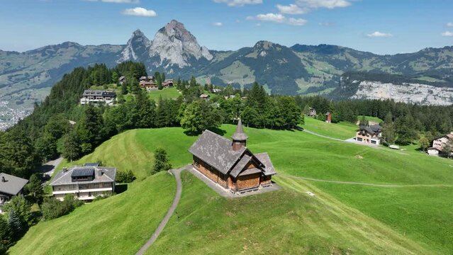 Fronalpstock Klingenstock wooden chapel in Stoos in central Switzerland a small wintersport ski resort village. Grassland alps alpine town on a clear sunny summer day. Clear mountain air and sky.