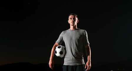 portrait of a young handsome soccer player man on a street playing with a football ball. © .shock