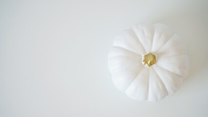 Close-up of a white ceramic pumpkin lamp on a white background, copy space. Decor concept Happy Halloween holiday. Thanksgiving day, symbol of autumn. Beautiful banner.