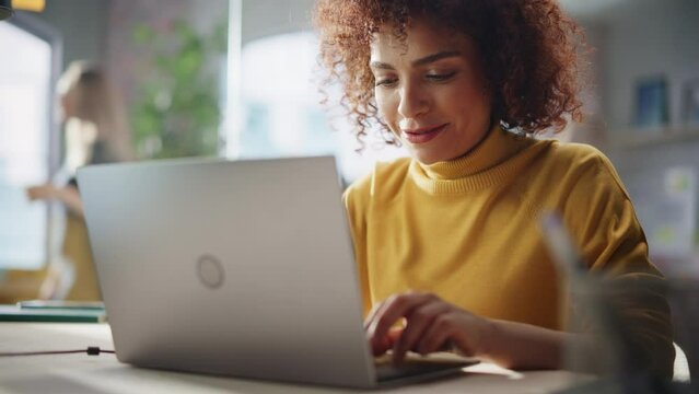 Confident Arab Businesswoman Sitting in Creative Agency, Manager Working on Implementing Modern Business Strategy for Client. Female Browsing Internet, Shopping Online on Laptop Computer.