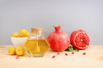 Rosh hashanah (jewish New Year holiday) concept. Pomegranate and honey traditional symbols