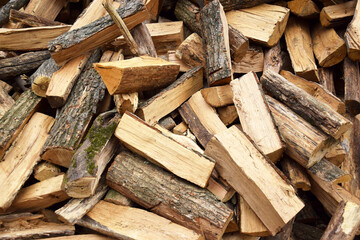 Lots of chopped oak firewood. Natural background.