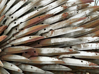 Metal garden blades layered fanned out, grunge metal background
