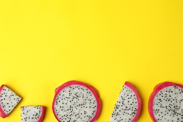 Delicious sliced dragon fruit (pitahaya) on yellow background, flat lay. Space for text