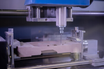 Milling machine cutting wooden workpiece from wood pulp, making 3d model at technology exhibition, factory. CNC engraving, woodworking, carving, industrial, manufacturing concept.