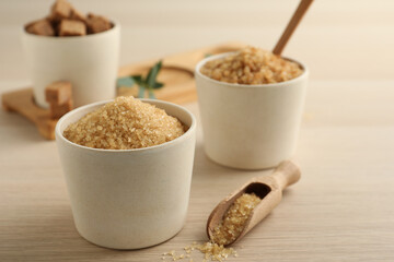 Bowls with different types of brown sugar on wooden table