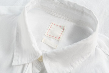 Blank clothing labels on white shirt, closeup