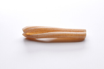 small composition of whole durum wheat pasta on a white background