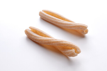 small composition of whole durum wheat pasta on a white background