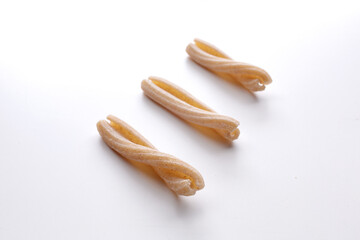 small composition of whole durum wheat pasta on a white background