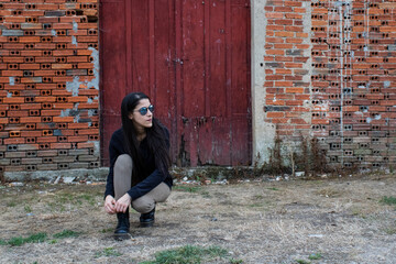 women binding boots in front of red door
