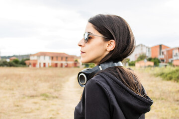 Women closeup outdoors with headphones and sunglasses