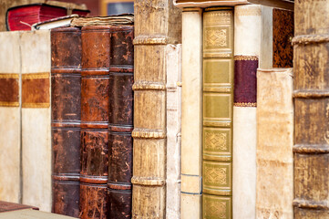 Old books in a row. Old leather covered books