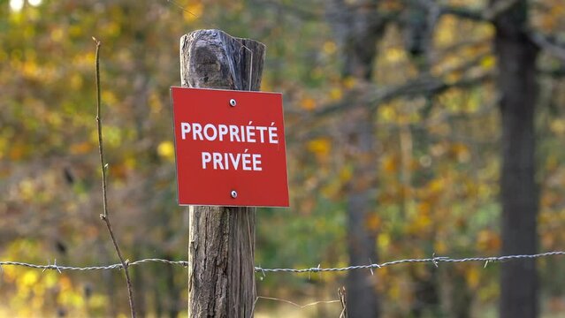 "Private property" French sign on a fence of a private property in Autumn