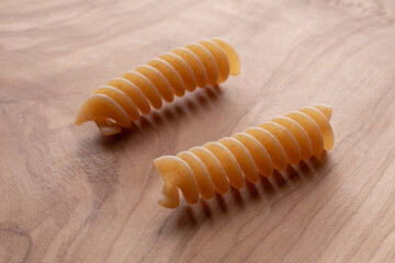 whole wheat durum wheat pasta on wooden background