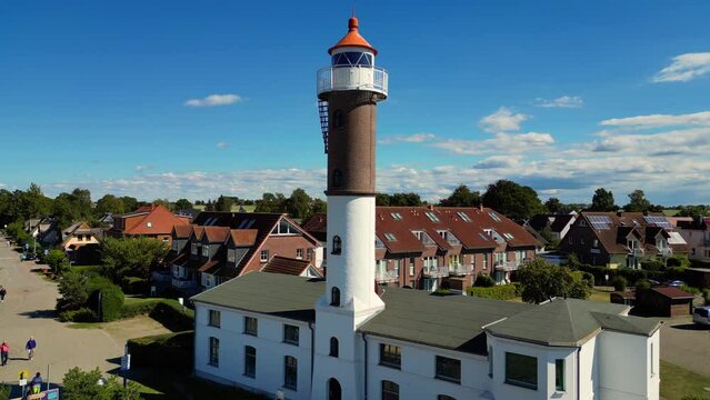historical lighthouse from 1872.
Marvelous aerial view flight pedestal up drone
of lighthouse on island poel germany at summer day August 2022. Marnitz 4k Cinematic from above