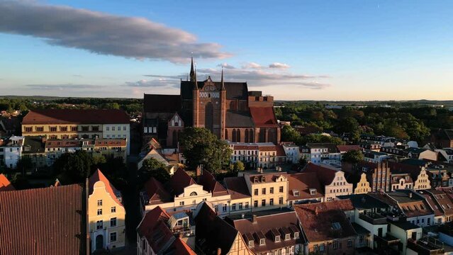 St. George Church the nave is 36m high
Gorgeous aerial view flight pedestal up drone
in Wismar germany at summer day golden hour August 2022. Marnitz 4k Cinematic from above