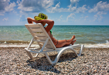 girl on the white chaise lounge on the beach