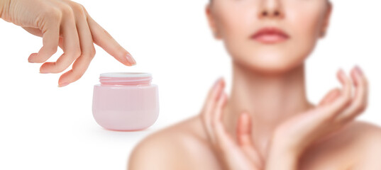 Female hand applying cream on beautiful female face.