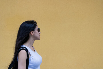 Women closeup yellow wall