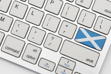 national flag of scotland on the keyboard on a grey background .3d illustration