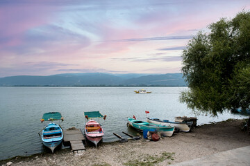 Naklejka na ściany i meble Fishing boats on the shore of Lake Apolyont. Uluabat, Gölyazı, Bursa, Turkey. Selective Focus Boat.