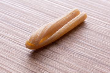 whole wheat durum wheat pasta on wooden background